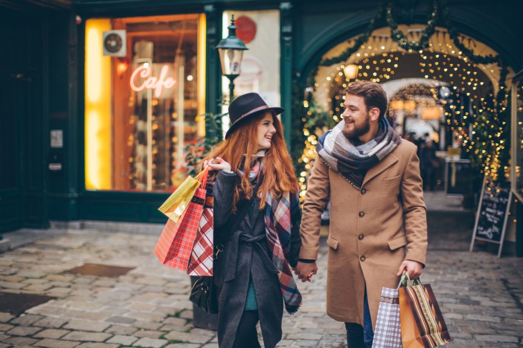 Happy man and woman shopping for the holidays